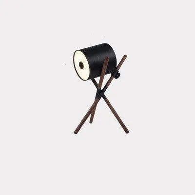 Modern three fork floor lamp with wooden stand and acrylic shade in a living room setting.