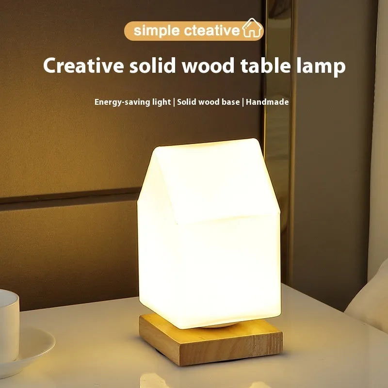 Nordic style solid wood USB table lamp in a cube shape with touch dimming on a wooden desk.