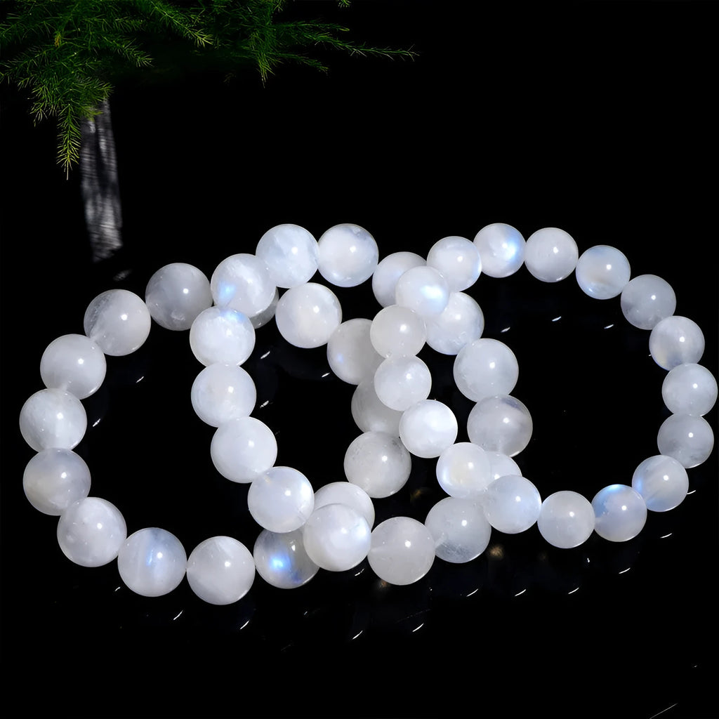 Natural blue moonlight round bead moonstone bracelet on a white background, showing polished geometric beads.