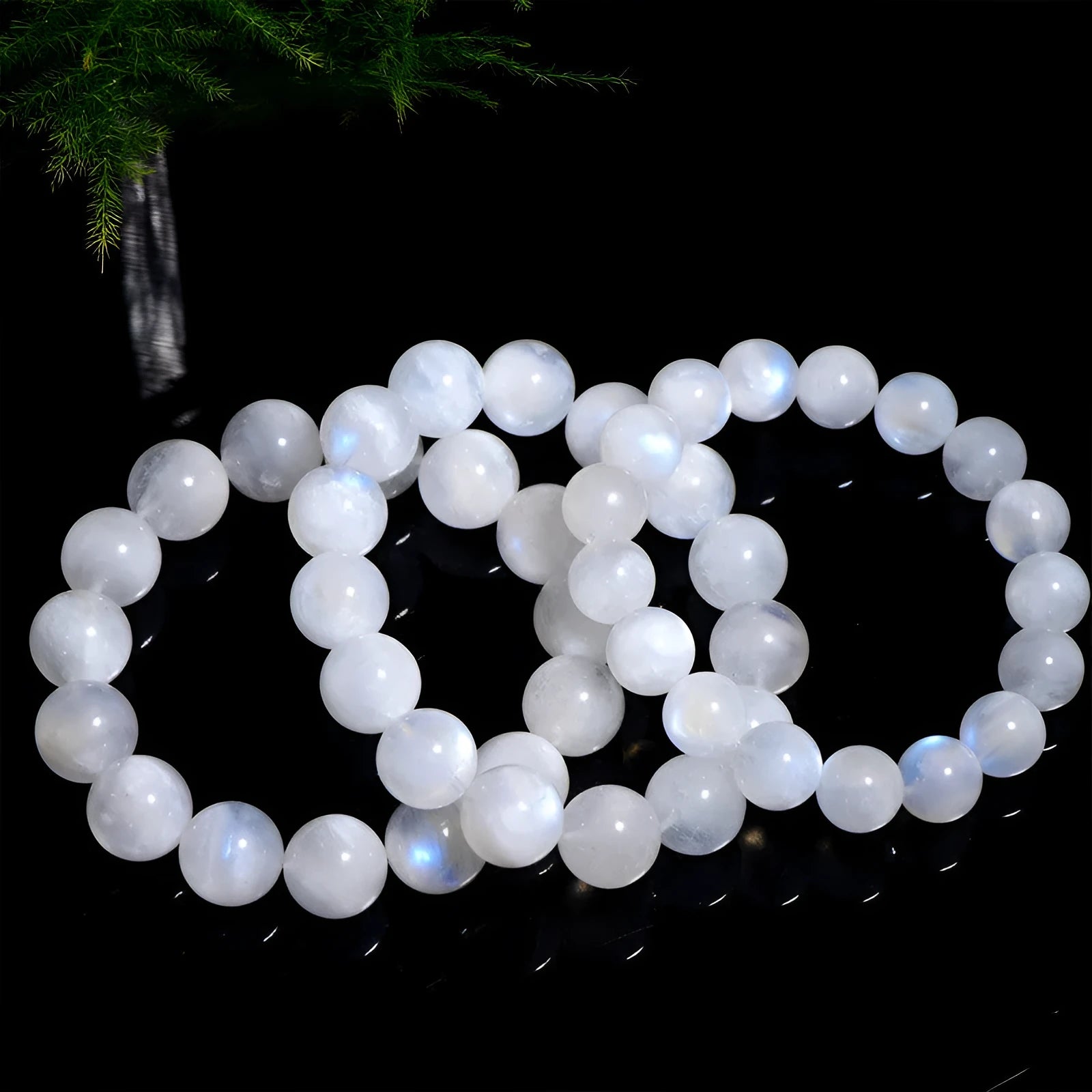 Natural blue moonlight round bead moonstone bracelet on a white background, showing polished geometric beads.