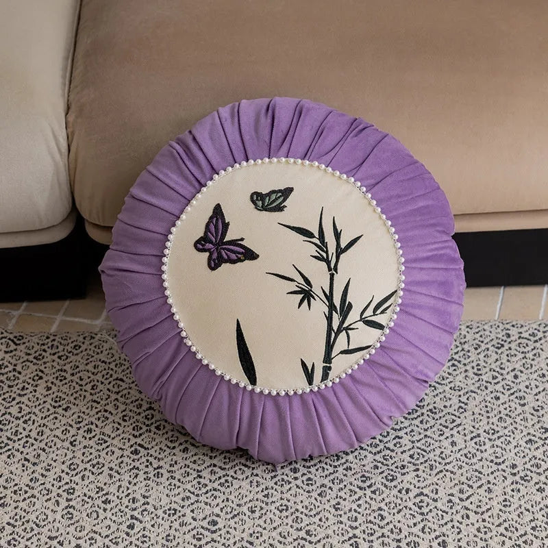 Square beige cushion with embroidered black butterfly pattern in Chinese style.