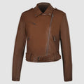 Women's short black PU leather biker jacket with an adjustable waist belt, shown on a model.