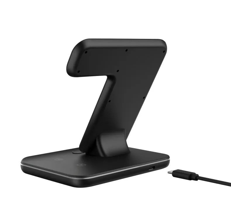 White three-in-one wireless charging station for phone, watch and headset on desktop