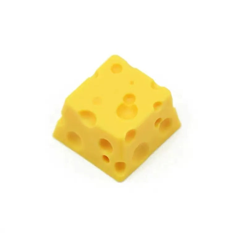 Yellow resin cheese-shaped key cap for mechanical keyboards, shown from a top-down angle.