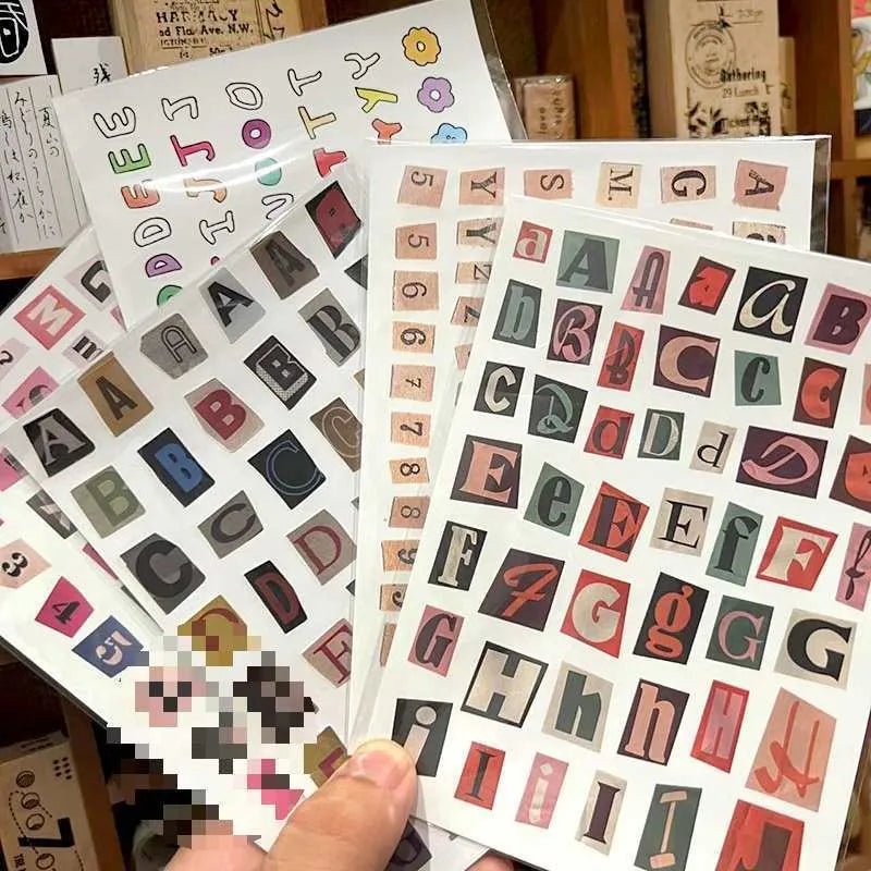 Pack of decorative stickers showing printed English alphabet letters and weekday words in a cute style for crafts.