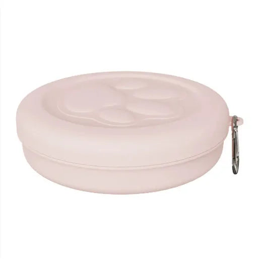 Collapsed and open views of a pink silicone dog bowl with matching sealing lid, next to a dog lead.