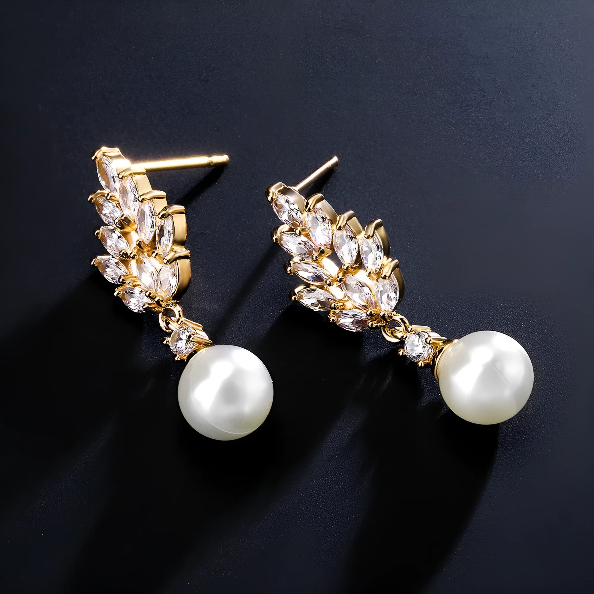 Geometric floral design earrings with micro inlaid zircon detail in gold, platinum, and rose gold finishes.