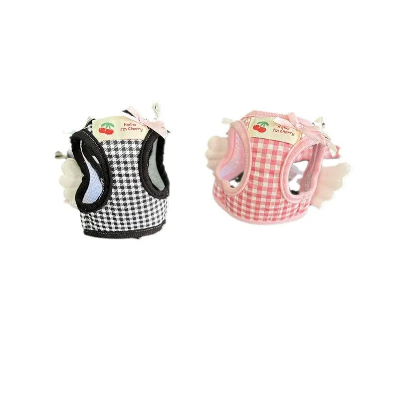 Pink and black cotton chest and back harness with rope leash for a small dog on a white background.