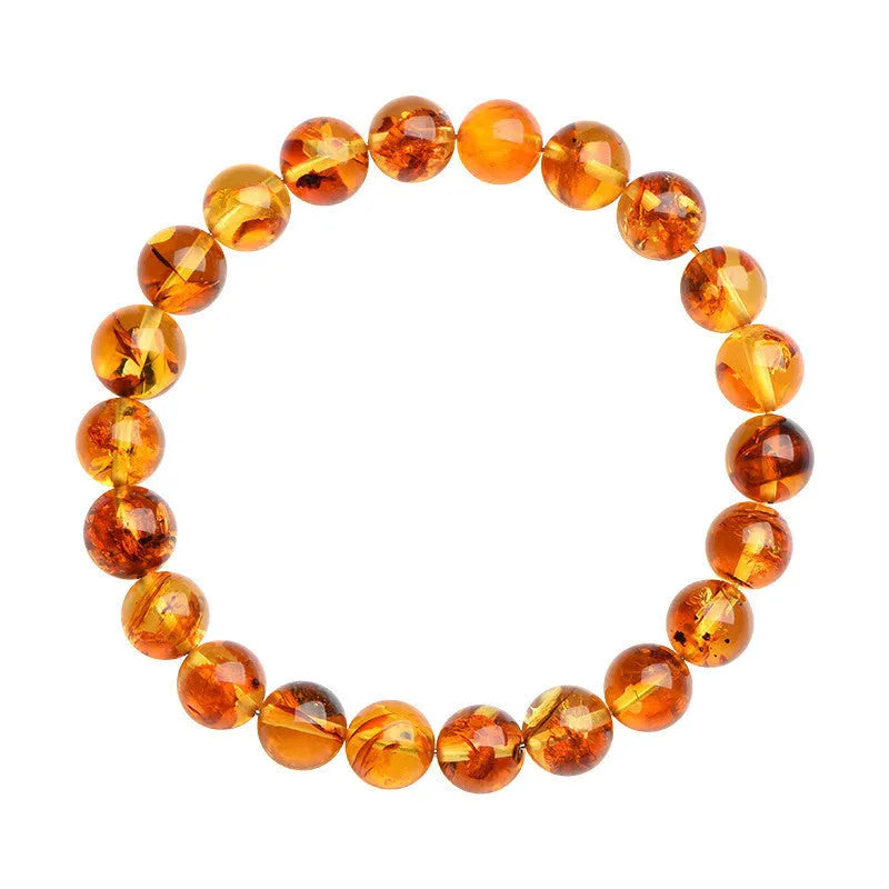 A natural yellow piebald amber bracelet with geometric beads for water purification.