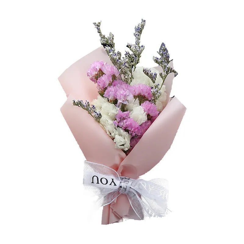 Mini dried flower bouquet clipped onto a car air vent, showing pink and white floral style.