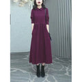 Purplish red women's long sleeve knee-length dress on a hanger, urban commute style.