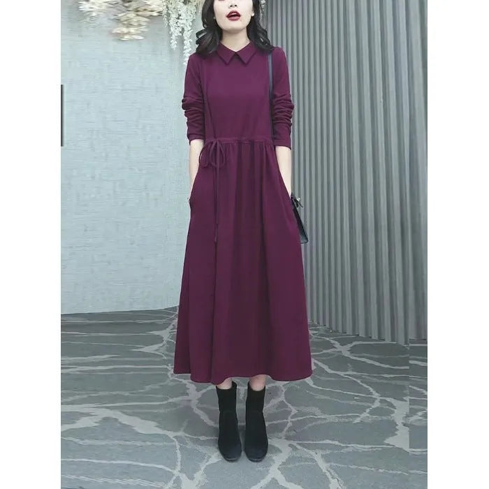 Purplish red women's long sleeve knee-length dress on a hanger, urban commute style.