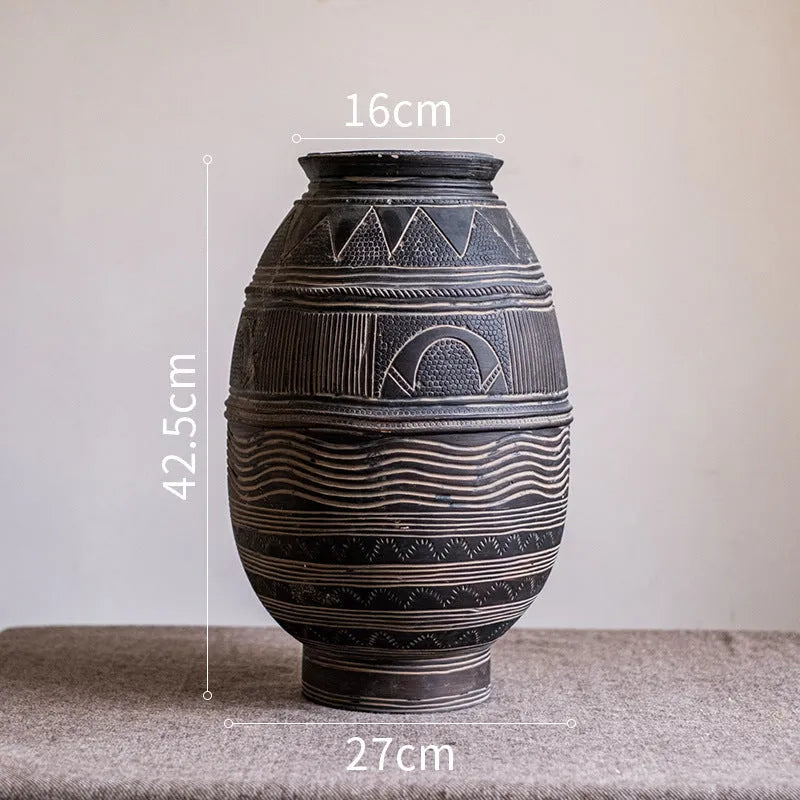 Medium cement flower pot with African ancient tank ethnic design and drainage hole.