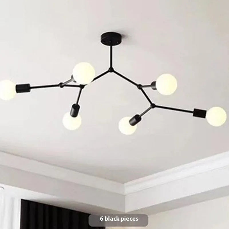 Minimalist black iron ceiling chandelier with six light heads in a Nordic style, against a white background.