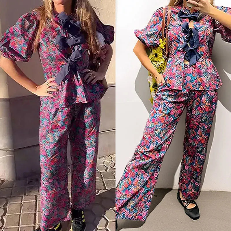 Women's floral print polyester trousers suit with puff sleeve top and matching trousers.