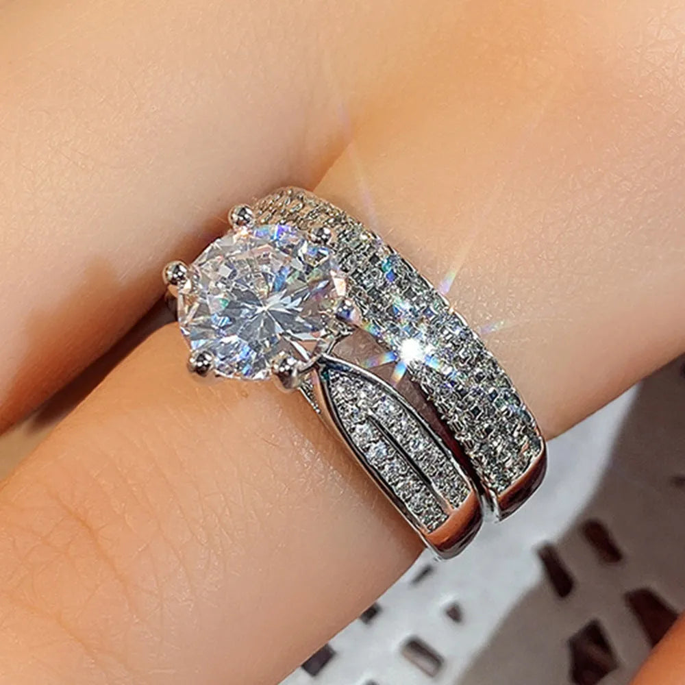 Geometric white gold colour alloy ring and bracelet combined into one continuous piece on a model's hand.