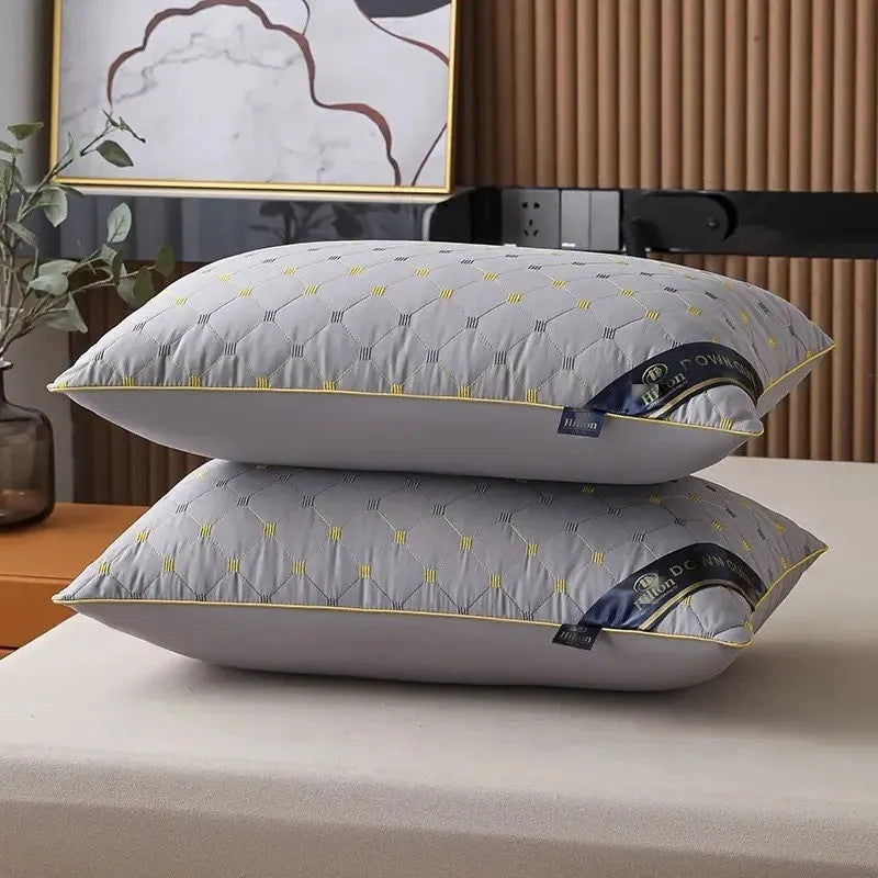 A white chemical fibre bedding pillow with a polyester shell, shown next to a blue argy wormwood patterned variant.