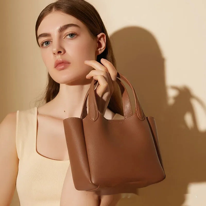 Genuine cattlehide leather retro cross body bucket bag in square vertical shape shown in brown colour.