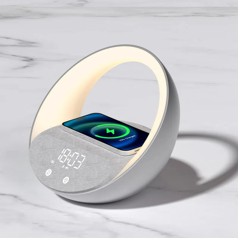 Beige multifunctional Bluetooth speaker with wireless charging surface and ambient LED lighting on bedside table