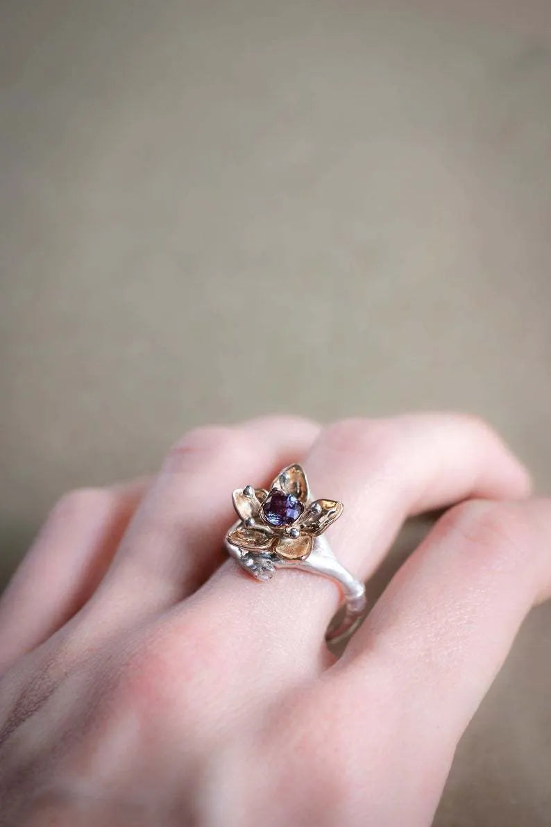 Silver two-tone floral geometric alloy ring for women on a plain background.