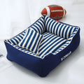 Navy stripes washable dog kennel mat with a blue mini pillow inside a crate.