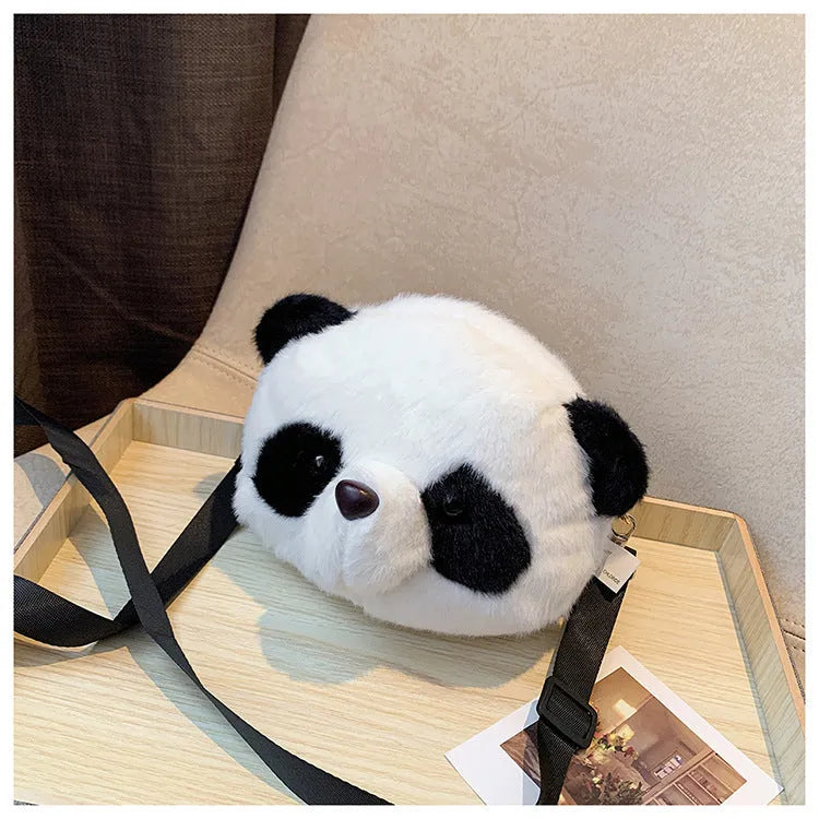 Soft plush crossbody bag in panda head colour with cylindrical shape and sandwich pocket.