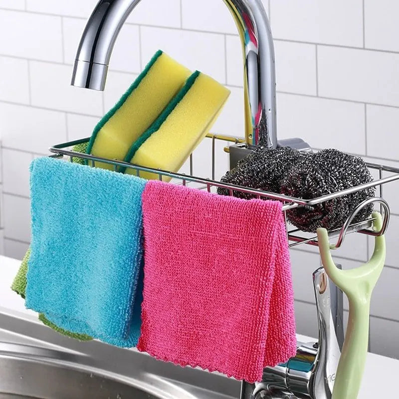 Adjustable stainless steel sink drain rack clipped onto a kitchen faucet with sponge and soap stored on the removable holder