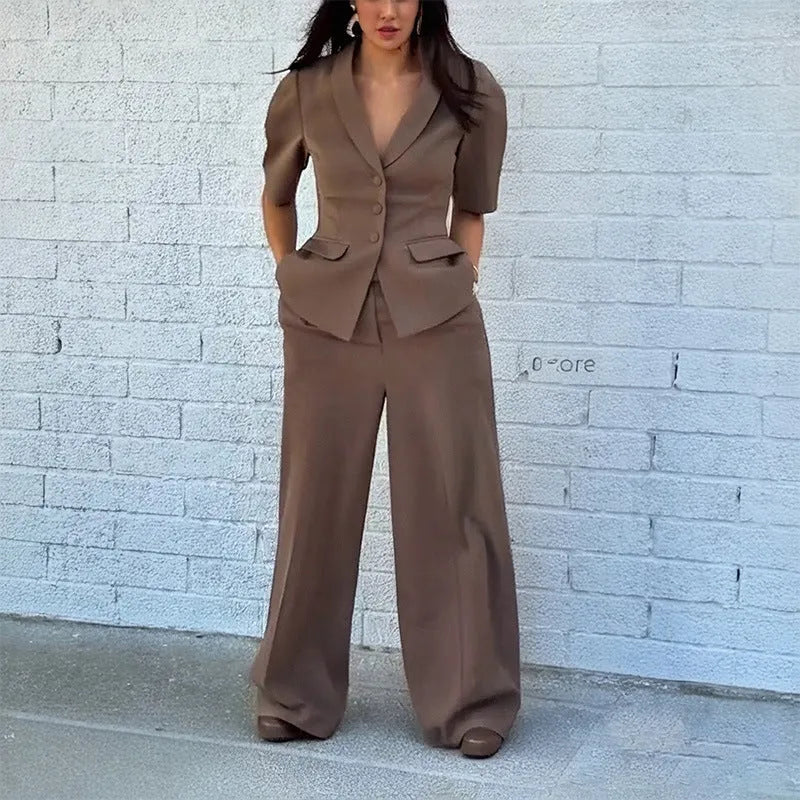 Brown men's slim fit polyester suit with long sleeve top and trousers laid flat.