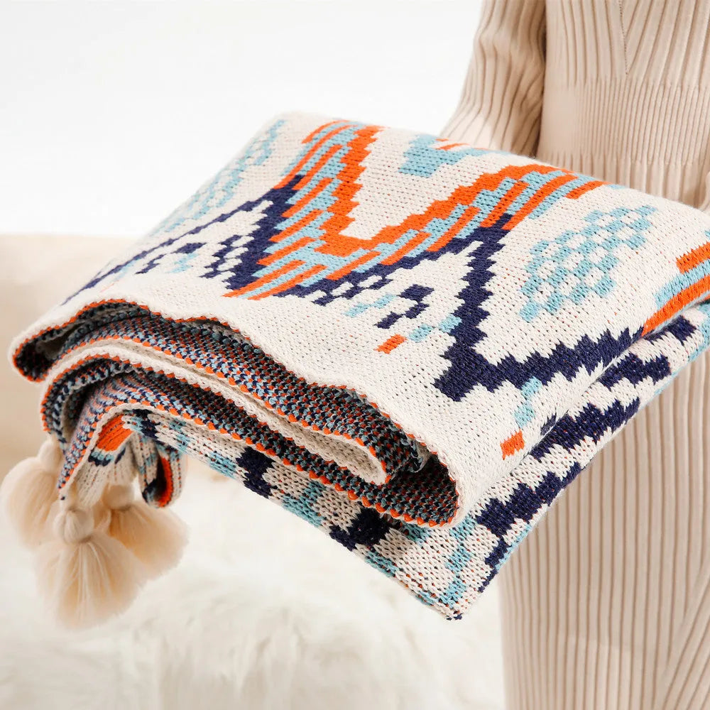 Bohemian-style acrylic knit sofa blanket with tassels in a geometric pattern
