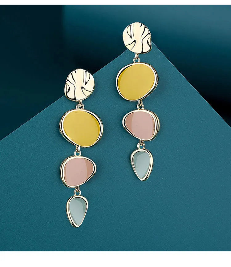 A pair of simple vintage wafer earrings in Morandi colours with a sterling silver needle post.