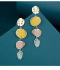 A pair of simple vintage wafer earrings in Morandi colours with a sterling silver needle post.