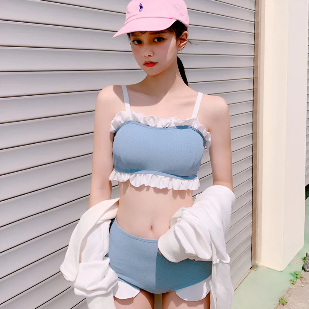 Solid-colour women's one-piece swimsuit with fashionable suspender straps, conservative cut.