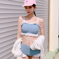 Solid-colour women's one-piece swimsuit with fashionable suspender straps, conservative cut.