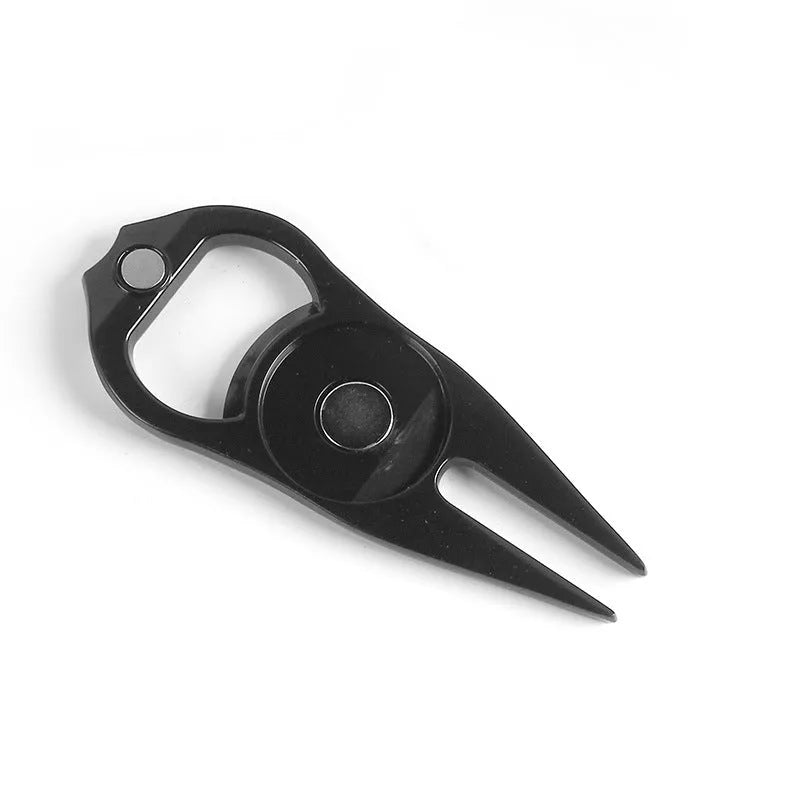 Zinc alloy golf multi-tool with ball yoke, bottle opener, and fork end on a green background.