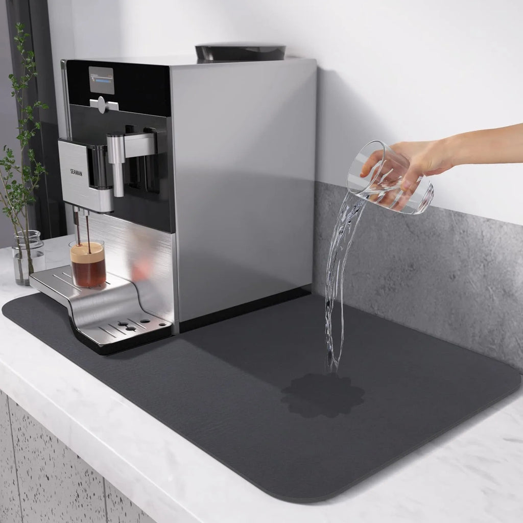 Square kitchen drain pad mat with black PU leather surface showing liquid absorption and rubber anti-slip backing