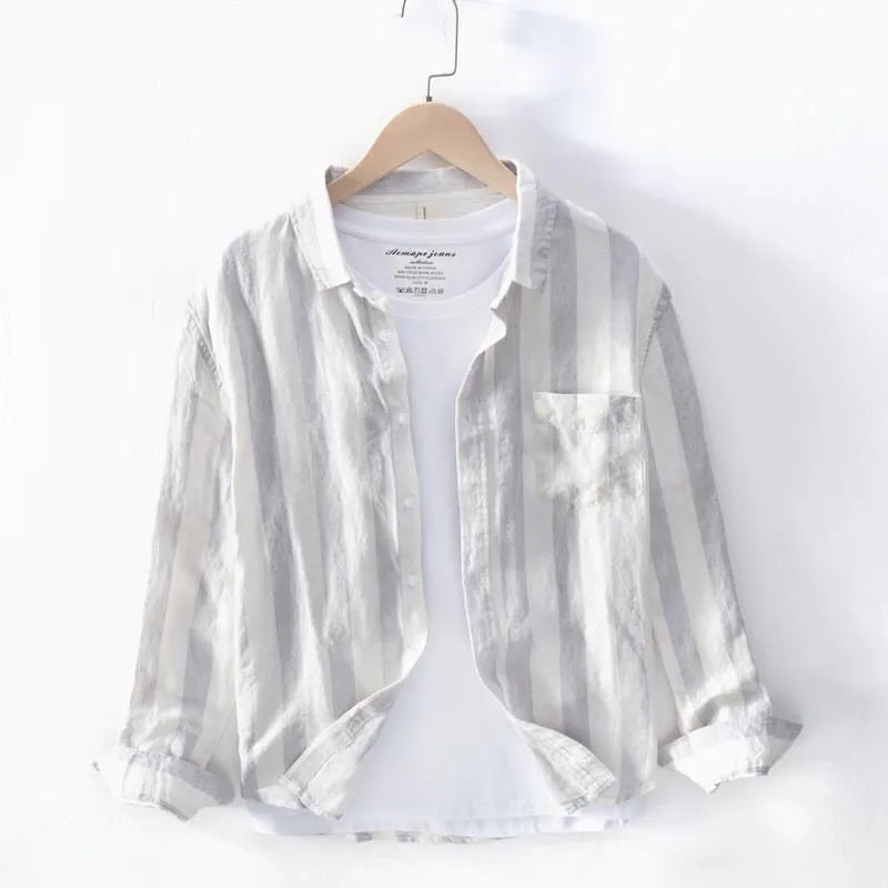 Blue long sleeve Hong Kong style loose fit men's casual shirt on a hanger.