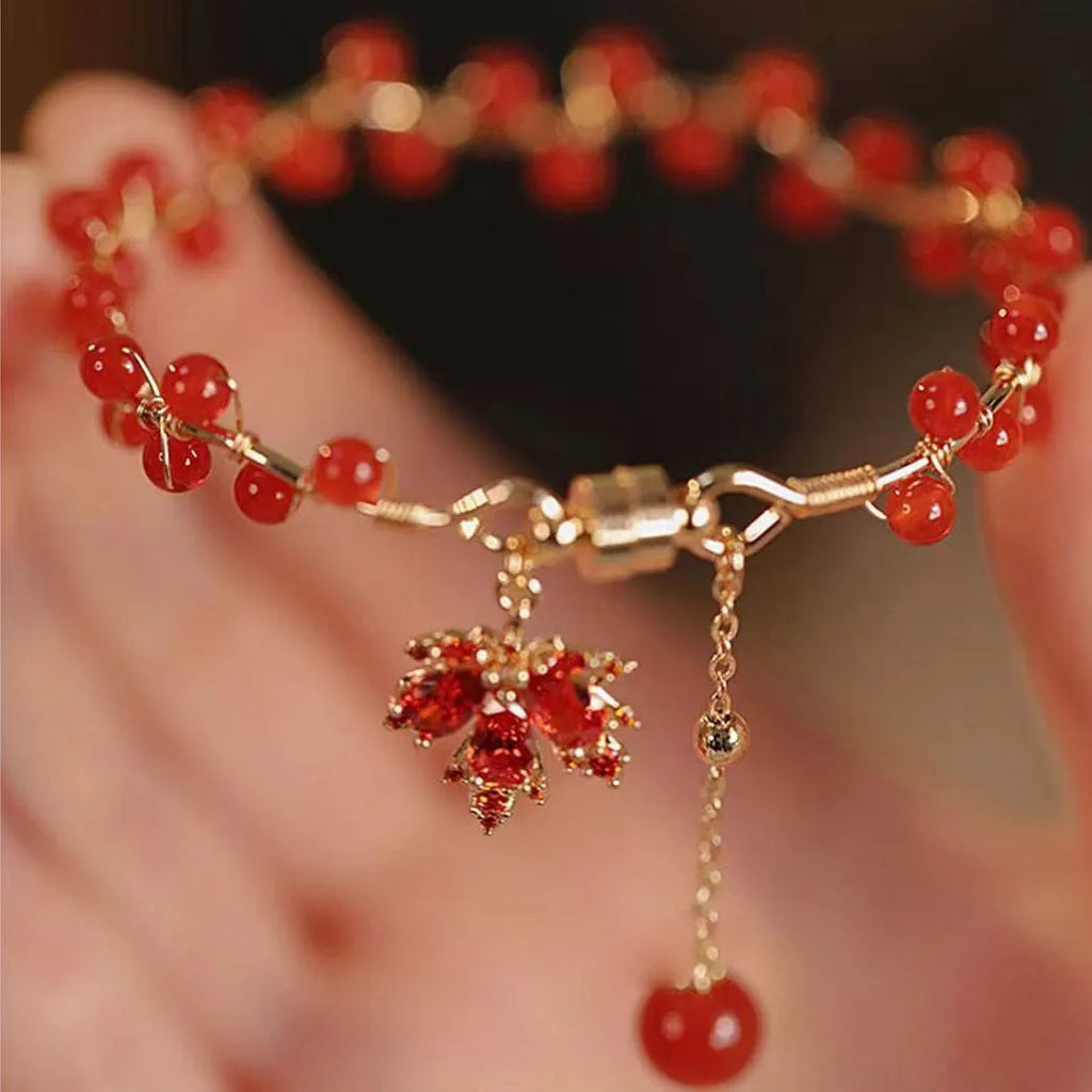 Red ginkgo leaf charm on an alloy magnetic bracelet in a Chinese style.