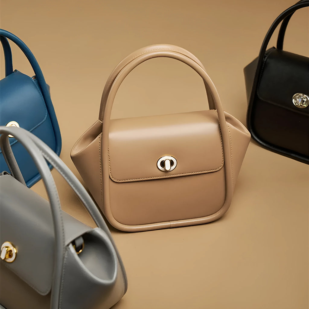 Winged shape leather tote handbag with a buckle and cross-body strap in cow leather