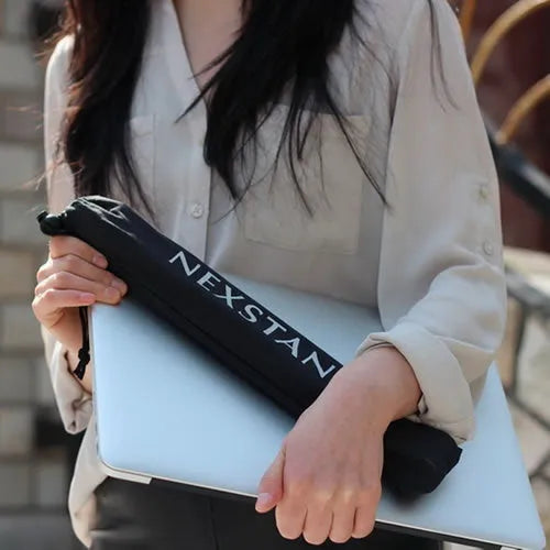 Black foldable enhanced nylon laptop stand shown open next to its portable carry bag.