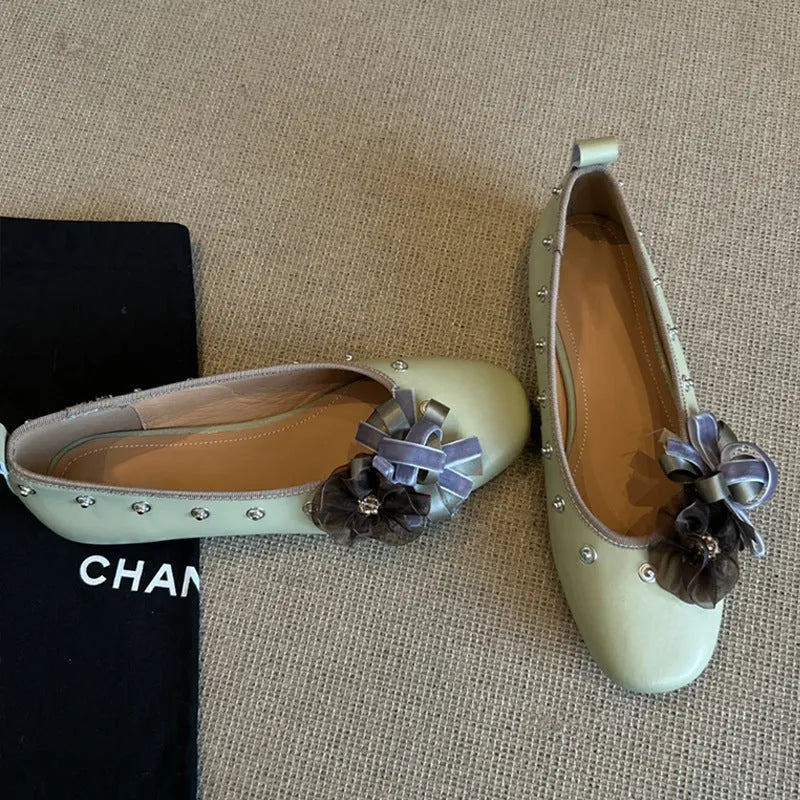 Women's silver Mary Jane loafers with flower rivets, buckle strap, round toe, and flat rubber sole.