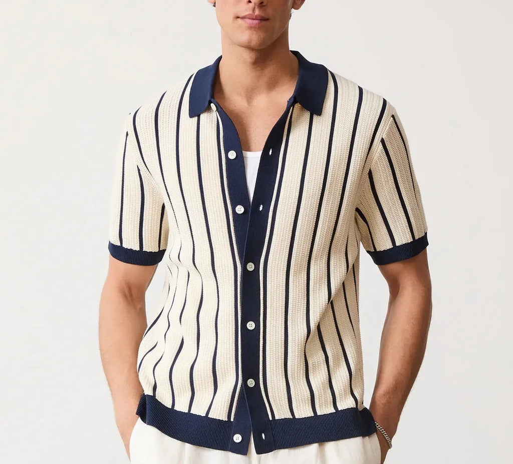Men's white asymmetric lapel short sleeve knitted shirt laid flat.