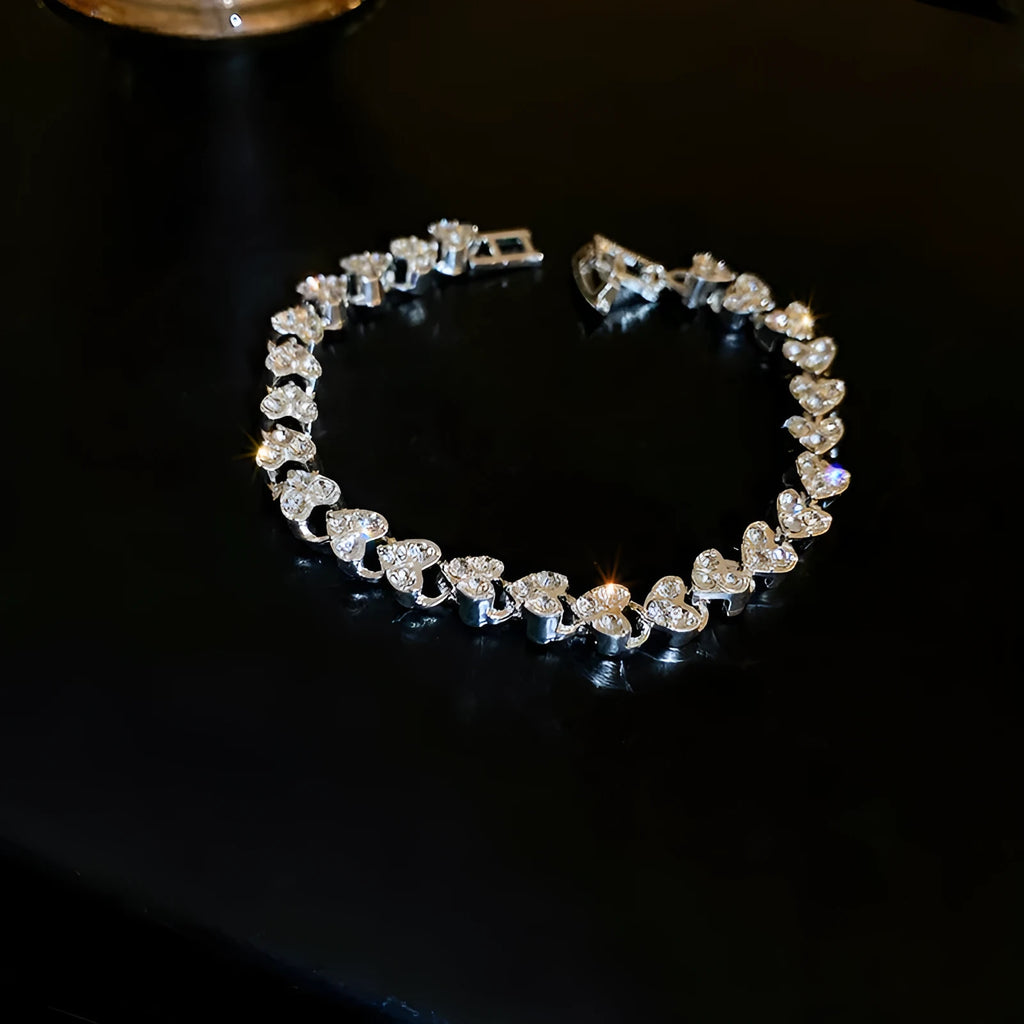 Silver metal bracelet with heart shape and inlaid zircon stones for women