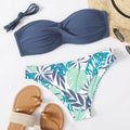 Green split push-up hard cup bikini top and coordinating briefs swimsuit laid flat.