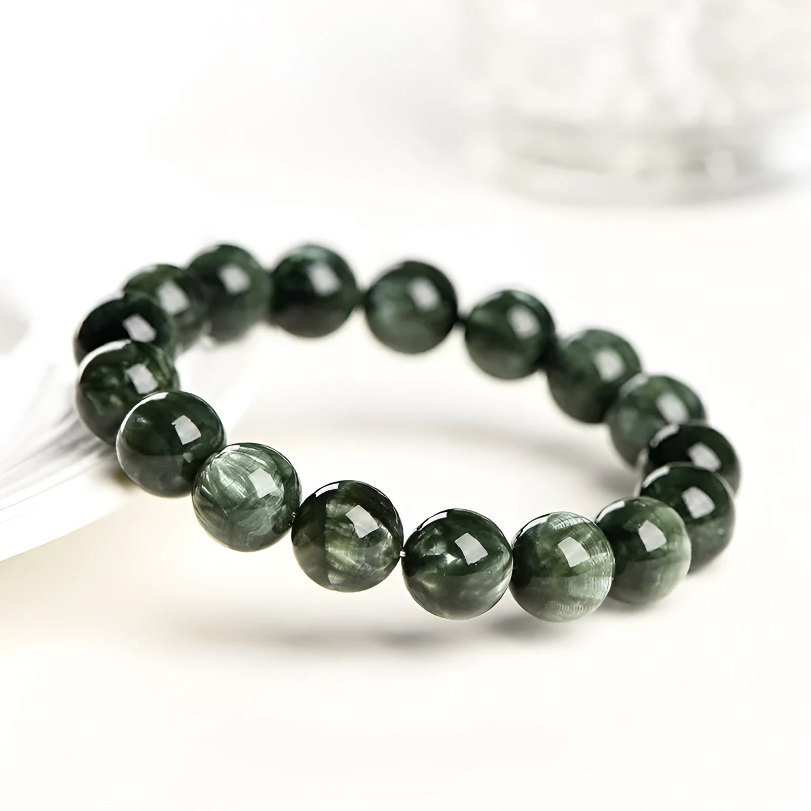 Green Dragon Crystal bracelet with 8-9mm round beads on a white background.