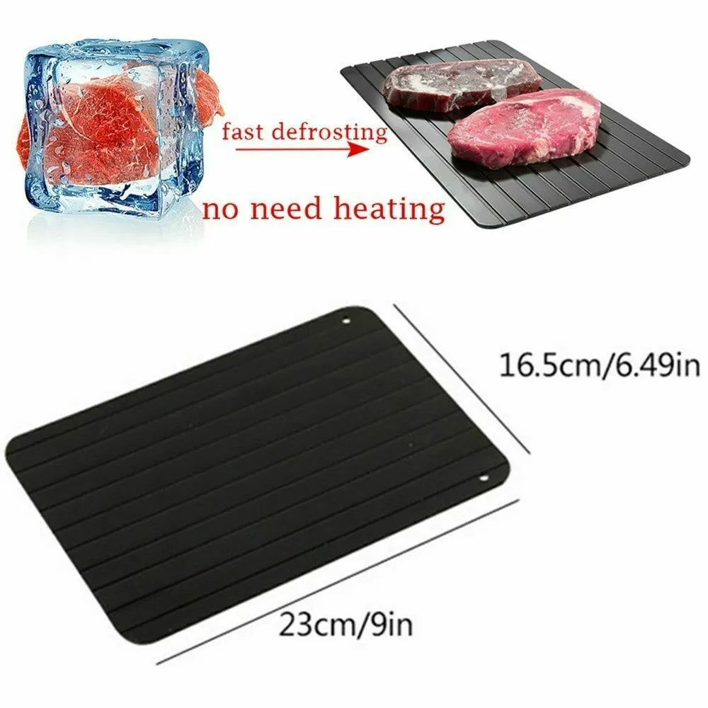 Black aluminium fast defrost tray for thawing frozen food on a kitchen counter.