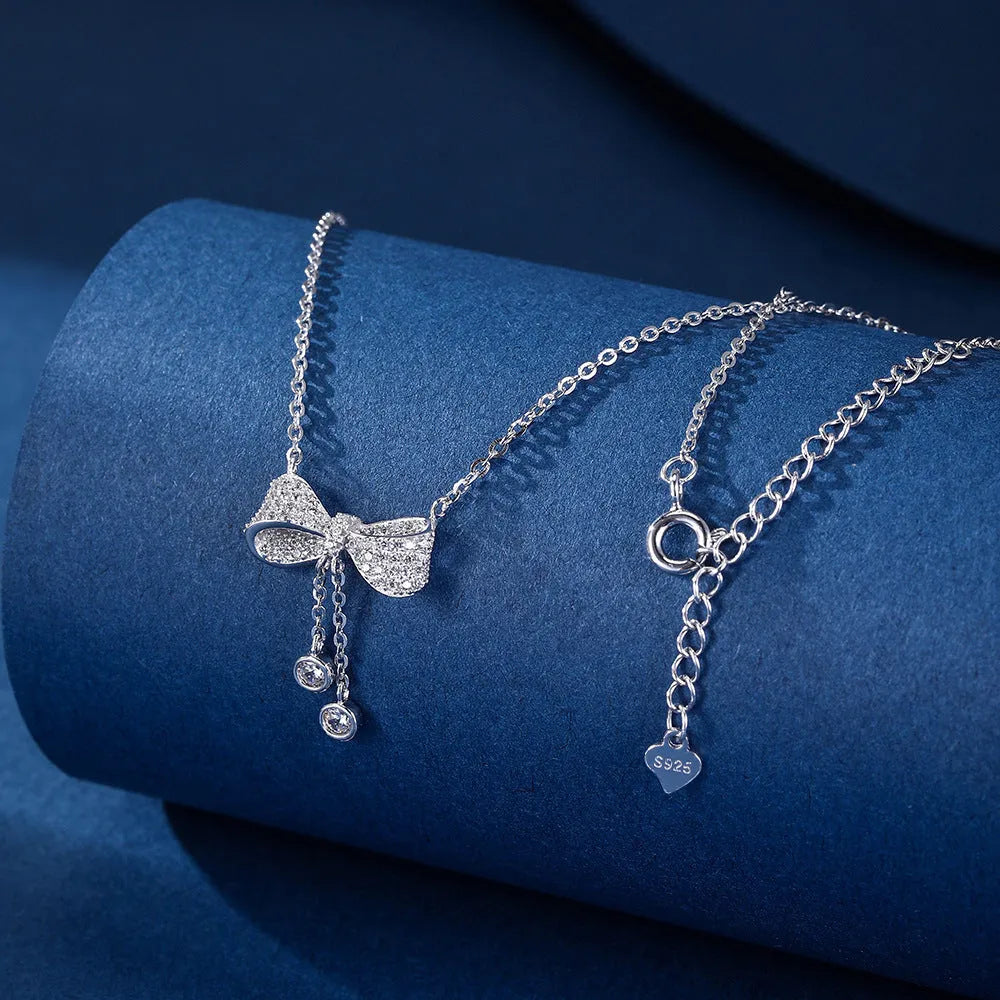 Sterling silver bow pendant necklace with O-ring chain on a 40-45cm adjustable chain.