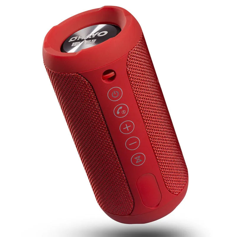 Compact waterproof Bluetooth speaker in camouflage colour, showing control buttons and sealed ports.