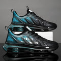 Men's black and green chunky sole platform trainers with mesh upper and lace-up design on a white background.
