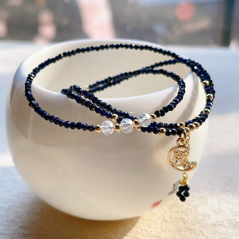 Blue gold sand stone three-ring multi-layer bracelet for women on a white background.