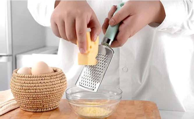 Kitchen utensil set with stainless steel heads and plastic handles including grater, whisk, and can opener